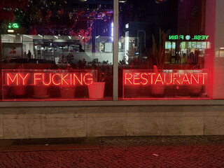 foto des eines restaurant schaufensters mit der neonschrift „MY FUCKING RESTAURANT“ an der müllerstrasse gegenüber kaufland (man sieht die reflektion von kaufland im schaufenster)